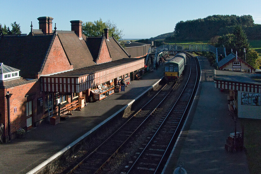 E56062 & E51228, Weybourne-Sheringham ECS, Weybourne station 
 In a further version of their running timetable, the North Norfolk Railway now run an empty stock DMU from Weybourne to Sheringham prior to their operations for the rest of the day. Class 101 DMU made up of E56062 and E51228 trundles out of Weybourne on a lovely autumn morning. Notice that the excellent and well-stocked secondhand bookshop already has its stock on display and is open for business. 
 Keywords: E56062 E51228 Weybourne-Sheringham ECS Weybourne station Class 101 First Generation DMU