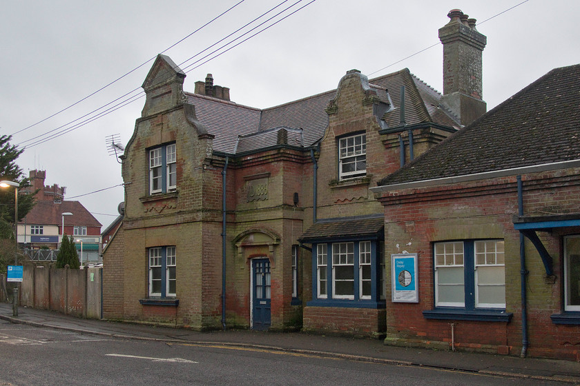 Frontage, New Milton station 
 The frontage of New Milton station still looks very smart despite it being an empty building now and with its most recent residents appearing to have moved on. It was built in 1888 to a sort of pseudo-Tudor style rather like New Milton's famous water tower whose turrets can be seen behind to the far left of the image. The building was subject to a planning application for it to be turned into a museum. 
 Keywords: New Milton station London and South Western Railway