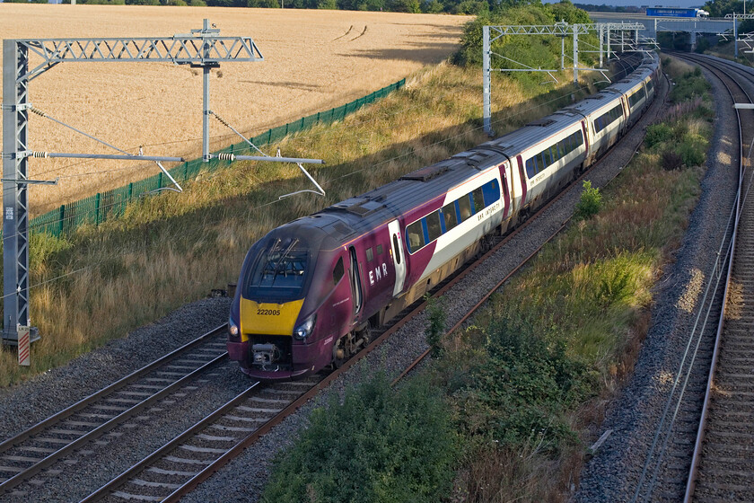 222005 & 222009, EM 05.30 Sheffield-London St. Pancras (1C08, 1L), Irchester SP927667 
 Just catching a little early morning sun the 05.30 Sheffield to St. Pancras EMR service passes Irchester a short distance south of Wellingborough. 222005 leads 222009 through the golden fields of Northamptonshire as it speeds towards the capital. Notice the HGV crossing the newly extended A45 road bridge at the top of the photograph. 
 Keywords: 222005 222009 05.30 Sheffield-London St. Pancras 1C08 Irchester SP927667 EMR East Midlands Railway