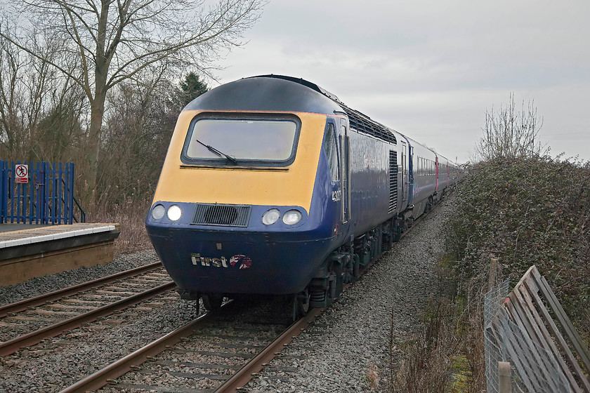 43037, GW 13.22 London Paddington-Worcester Foregate Street (1W27), Ascott-under-Wychwood station 
 With the winter light beginning to fail, 43037 'Penydarren' passes at speed through Ascott-under-Wychwood station leading the 13.22 Paddington to Worcester Foregate Street . A bit of a head-on shot but after the crossing barriers went down on the nearby level crossing Andy and I had nowhere to go to get the shot but the platform end. Notice the reinstated platform on the up side following the line's re-doubling in 2011 
 Keywords: 43037 1W27 Ascott-under-Wychwood station