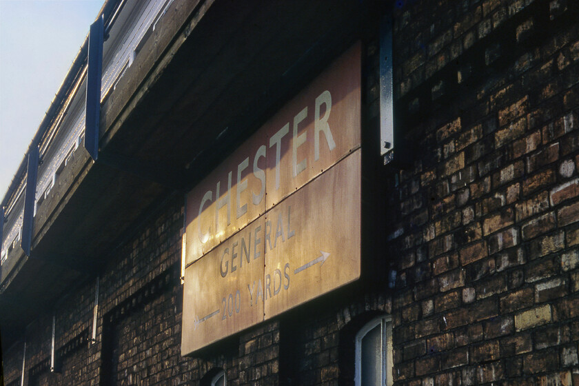 BR (M) enamel, Chester No. 4 signal box 
 Catching the last of the evening summer sun a British Railways (London Midland) running-in sign is seen attached to the front of Chester No. 4 signal box. Notice that the sign is made up of four large enamel pieces bolted together. As always when I see these items in my old photographs, and knowing them to no longer be there (No. 4 box was decommissioned in early May 1984 and knocked down during the following summer) I wonder where this fine sign ended up......? 
 Keywords: BR London Midland enamel Chester No. 4 signal box