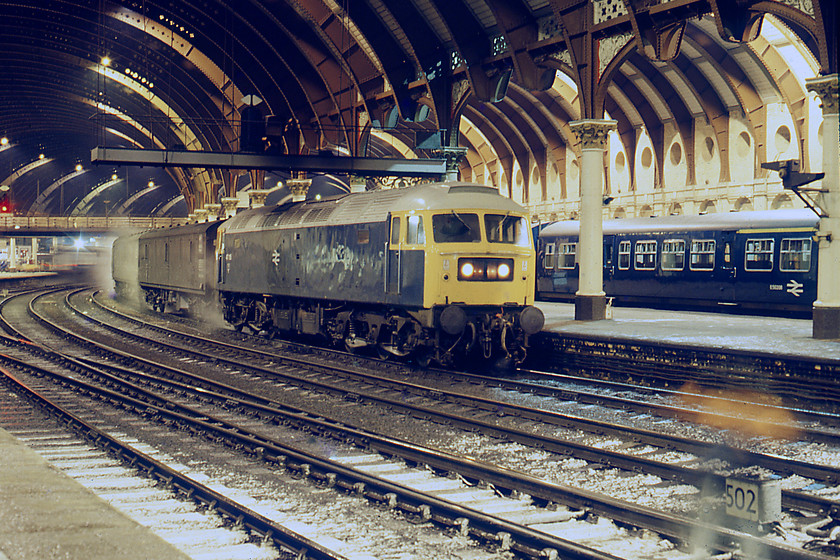 47115, 20.00 London King's Cross-Aberdeen, York station 
 With its Spanner Mk. III boiler working well, 47115 is seen at York leading the 1S60 20.00 London King's Cross-Aberdeen. It was always nice to see a Stratford Class 47 as the depot seemed to turn their engines out looking smarter than the rest. In addition, they also personalised their engines with such things as their trademark silver roofs as shown here. Time exposure photographs utilising long shutter speeds, I have in my records that this one was about ten seconds at f8, bring a whole new atmosphere to railway scenes as well as strange effects such as the reflection of something or other, often with a ghostly appearance, like in the bottom right corner. 
 Keywords: 47115 20.00 London King's Cross-Aberdeen York station