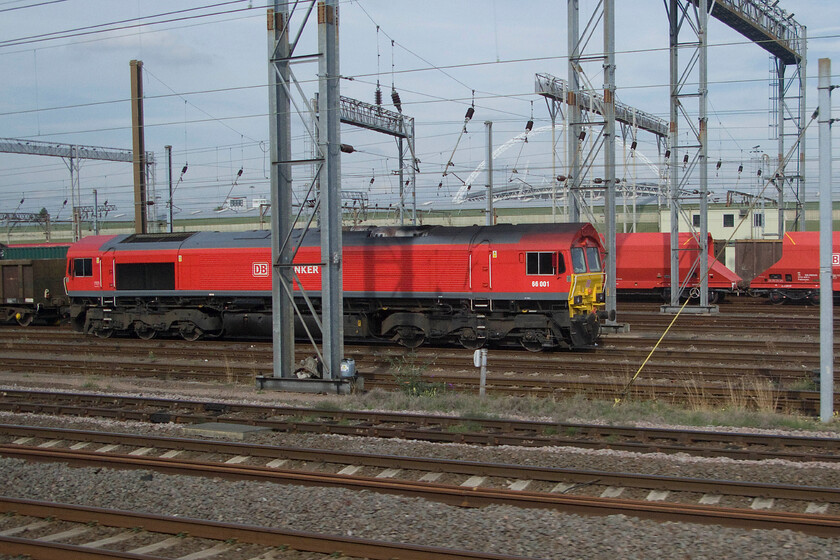 66001, stabled, Wembley Yard 
 Pioneer Class 66 66001 looks smart in its DB Schenker cherry red livery despite being sixteen years old but this paint scheme was only applied last year. It is seen resting in Wembley Yard between duties on a Sunday afternoon. 
 Keywords: 66001 Wembley Yard