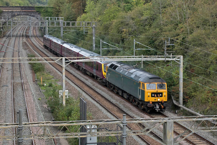 47727 & 360116, 10.06 Northampton EMD-Crickelwood South Sidings (5Q97, 85E), A508 bridge 
 After an earlier morning farce that saw 47727 'Edinburgh Castle/Caisteal Dhn Eideann heads south from Leicester via a reversal at Nuneaton rather than heading north from London with another EMR Desiro, it is finally seen leading 360116 through Roade. It is working as the 5Q97 10.06 Northampton EMD (Siemens' Depot) to Cricklewood following repairs and exams. It seems quite bizarre that these units that operate on the MML, just thirteen miles due east of this location, have to be dragged to and from for their maintenance work and why they cannot under their own power - can somebody enlighten me, please? However, it does give me the opportunity to photograph sixty-year-old locomotives still out at work on the mainline! 
 Keywords: 47727 360116 10.06 Northampton EMD-Crickelwood South Sidings 5Q97 A508 bridge EMR Desiro Edinburgh Castle/Caisteal Dhn Eideann