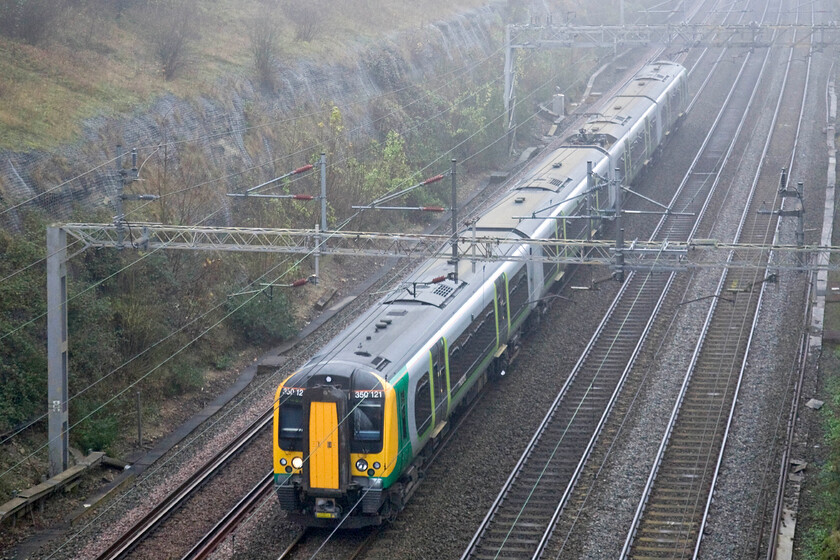 350121, LM 09.49 Euston-Birmingham New Street (1W07), Roade cutting 
 350121 works the 09.49 Euston to Birmingham New Street London Midland service though Roade cutting. Unusually for a Saturday, the train is composed of just one four-car set rather than the more usual eight-car formation 
 Keywords: 350121 09.49 Euston-Birmingham New Street 1W07 Roade cutting London Midland Desiro