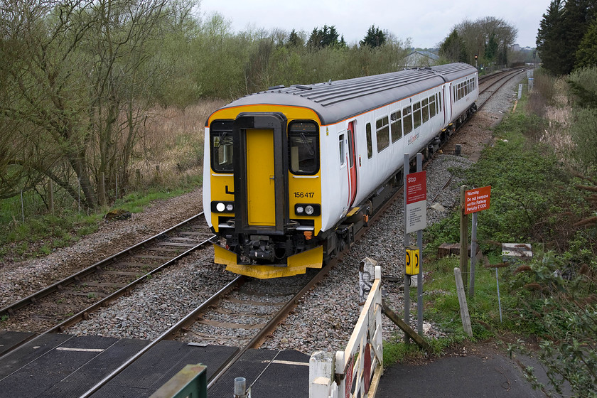 156417, LE 12.45 Norwich-Sheringham (2S18), Whitlingham Lane crossing TG266083 
 It appears in this photograph that the crossing at the bottom of the photograph can allow vehicles to cross the line. However, the fixed crossing goes nowhere with nothing but a grassy and somewhat overgrown footpath on the left side of the line. So, I doubt that there will be anybody calling the signalman from the 'phone. 156417 approaches the crossing with the 12.45 Norwich to Sheringham 2S18 Greater Anglia service. 
 Keywords: 156417 12.45 Norwich-Sheringham 2S18 Whitlingham Lane crossing TG266083 Abellio Greater Anglia