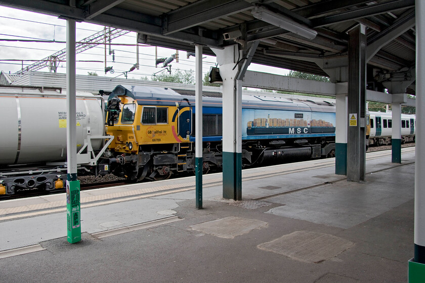 66709, 10.15 Kidderminster-Tonbridge West Yard (6Z66, 20L), Northampton station 
 66709 'Sorrento' brings up the rear of the very late running 10.15 Kidderminster to Tonbridge Yard 6Z66 train as it passes through Northampton station. Unfortunately, I had to take this photograph through the palisade fencing as my wife and I had left the building and were waiting for a taxi home. The brand new 'smart' weedkilling train is returning to its Kent following testing on the Severn Valley Railway, see.... https://www.pressreader.com/uk/rail-express-9L24/20210709/282102049678018 
 Keywords: 66709 10.15 Kidderminster-Tonbridge West Yard 6Z66 Northampton station Sorrento GBRf GB Railfreight