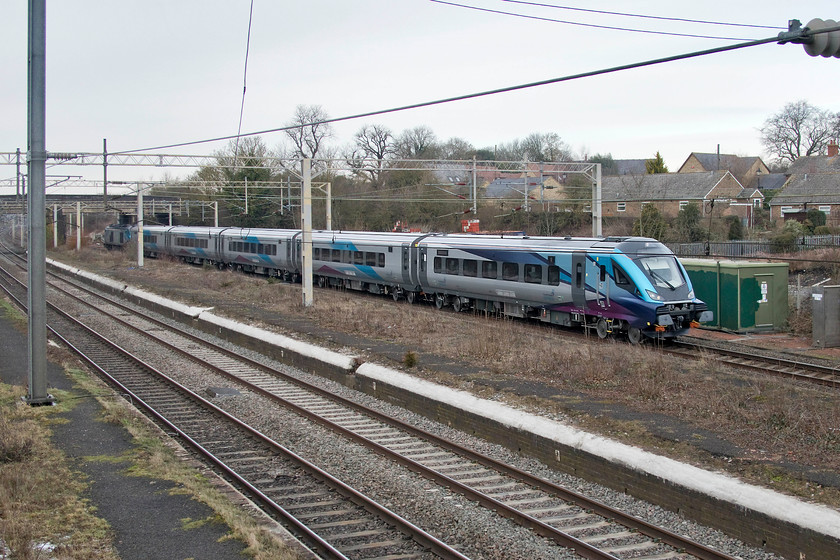 12809, set 8 & 68032, 08.12 Carlisle-Bletchley CS (6B21), site of Castlethorpe station 
 TPE's set eight, led by 12809 with 68032 pushing at the rear, passes Castlethorpe nearing the end of the 08.12 Carlisle to Bletchley test run. The Mk. 5A stock, built by Construcciones y Auxiliar de Ferrocarriles (CAF) at its Beasain plant in northern Spain, looks smart but for the clumsy and cluttered underbody components. Leading driving trailer (DT) 12809 is doing today's run without its nose cone, unless it's flown off and is lying somewhere on the WCML! It will take a little getting used to seeing trains running without yellow hi-viz fronts, more will be arriving in the next few years. 
 Keywords: 12809 set 8 68032 08.12 Carlisle-Bletchley CS 6B21 site of Castlethorpe station