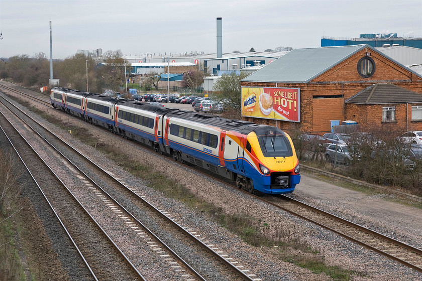 222014, EM 12.16 Corby-London St. Pancras (1P39), site of Isham & Burton Latimer station (C. 20.11.1950) 
 Taking the up slow line past the site of the former Isham and Burton Latimer station (closed 01.10.50) 222014 is seen with the 12.16 Corby to St. Pancras service. In the background is the station's former goods that is now the property of breakfast cereal manufacturer Weetabix who's factory dominates the scene. They have made good use of the goods shed to support their advertising hoarding informing passing rail passengers exactly where they are passing! 
 Keywords: 222014 12.16 Corby-London St. Pancras 1P39 site of Isham & Burton Latimer station East Midlands Train Meridian