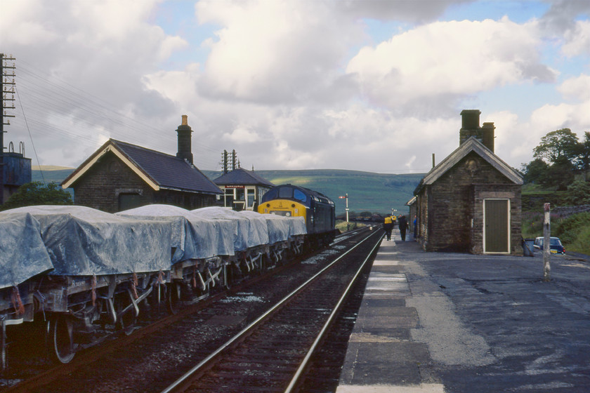 40175, down freight & 40179 (failed having been rescued by 5690), up freight, Garsdale station 
 At Garsdale station high up on the Settle and Carlisle railway 40179 has just arrived with a down freight that appears to be a china clay working composed of the five-plank wagons rather than those with the hoods. I suspect that it was heading to Ayr for use in the paper mill. Notice 40179 at the head of an up freight in the loop at the far end of the station with the loco. having disgraced itself earlier by failing and having to be rescued by 5690 'Leander'. 
 Keywords: 40175, down freight & 40179 (failed having been rescued by 5690), up freight, Garsdale station