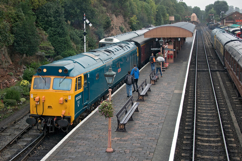 50035, 13.50 Kidderminster-Bridgnorth, Bewdley station 
 With the rain starting to come down again, 50035 'Ark Royal' arrives at Bewdley station leading the 13.50 Kidderminster to Bridgnorth diesel gala service. Andy and I took this train back up the line to Hampton Loade enjoying some English Electric action! Notice D1062 'Western Courier' waiting to the right that will work the 14.27 shuttle service to Kidderminster. It was also nice that we were able to share our compartment with Sally Murray the widow of well known and respected SVR and prolific Class 50 photographer Ian Murray who sadly recently died after a long battle with cancer. She was travelling in memory of her late husband behind one of his beloved Class 50s, see..... https://www.pressreader.com/uk/heritage-railway/20210803/282462826962925 
 Keywords: 50035 13.50 Kidderminster-Bridgnorth Bewdley station Ark Royal