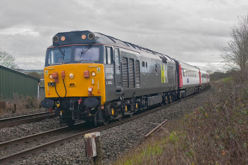 50008, return leg of Shooter's Swansong, 11.33 London Marylebone-Stratford-on-Avon (1Z22, 2E), Clattercote SP455490 
 Our third and final sighting of the Shooter's Swansong charter as it heads back from London Marylebone as the 1Z22 11.33 to Stratford-on-Avon. Looking very smart in its Hanson and Hall livery 50008 'Thunderer' shatters the peace of the Oxfordshire countryside at Clattercote near Claydon as it heads north. Having been put together in record short time following the death of the career railwayman Adrian Shooter and running in the somewhat 'dead' time just after Christmas the charter did not appear to be particularly well loaded with a lot of empty seats seen as the train passed. It also clashed with UKR's Class 56 Farewell charter that will no doubt have attracted a number of railtour punters. 
 Keywords: 50008 Shooter's Swansong 11.33 London Marylebone-Stratford-on-Avon 1Z22 Clattercote SP455490 Hanson and hall Warship Thunderer