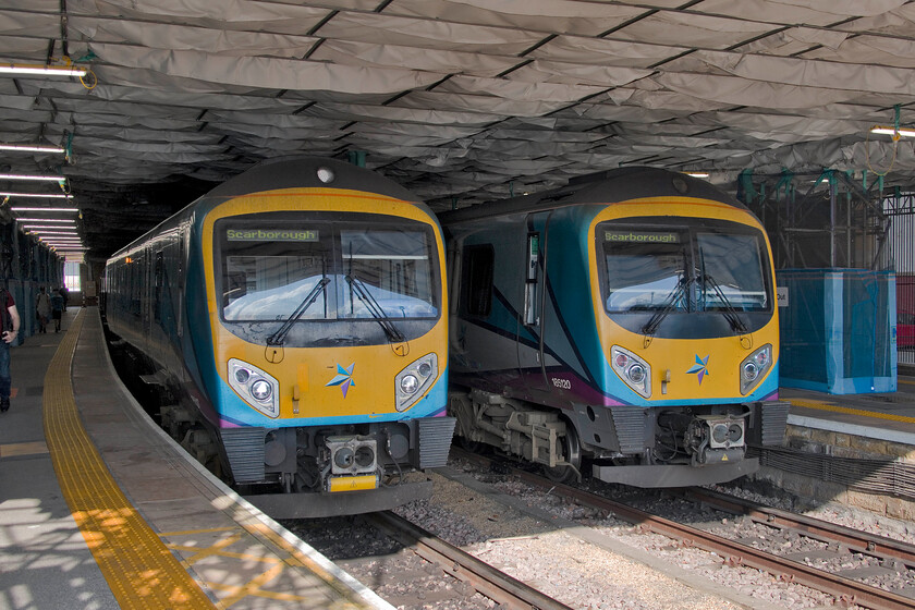 185143, TP & 185120, TP 16.48 Scarborough-York (1U68, 6L), Scarborough station 
 In the gloom of Scarborough station under the temporary access scaffold structure, a pair of TPE Class 185 Desiros wait their next turn of duty. To the left 185143 will work an unidentified westbound service whilst to the right the 16.48 service to York will be worked by 185120. I really do not understand why through services to Liverpool Lime Street have been withdrawn necessitating a cumbersome and time-consuming change at York. 
 Keywords: 185143 185120 16.48 Scarborough-York 1U68 Scarborough station Trans Pennine Express TPE