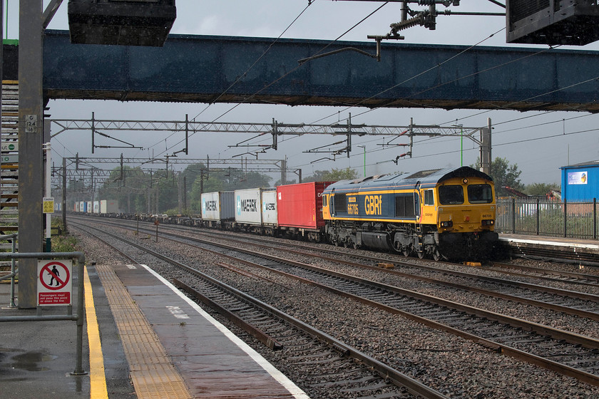 66705, 14.17 Trafford Park-Felixstowe North (4L18), Rugeley Trent Valley station 
 What's this....is this the sun coming out? After a day of pretty relentless rain, the sun has just broken through the cloud but it is still actually drizzling. GBRF's 66705 'Golden Jubilee' heads the 4L18 14.17 Trafford Park to Felixstowe Freightliner through Rugely Trent Valley. When just over a year old, in June 2002, it was named to celebrate the queen's fifty years on the throne, it has carried this name ever since. 
 Keywords: 66705 14.17 Trafford Park-Felixstowe North 4L18 Rugeley Trent Valley station