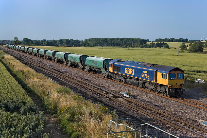 66706, 13.56 West Burton PS-Theale Lafarge (6V08), Harrowden Junction 
 The 13.56 West Burton Power Station to Theale empties passes Harrowden Junction led by a very smart 66706 'Nene Valley'. In contrast to the de-branded and tatty former Freightliner wagons GBRf's locomotive looks very smart in the lovely evening sunshine. 
 Keywords: 66706 13.56 West Burton PS-Theale Lafarge 6V08 Harrowden Junction. GBRf Nene Valley