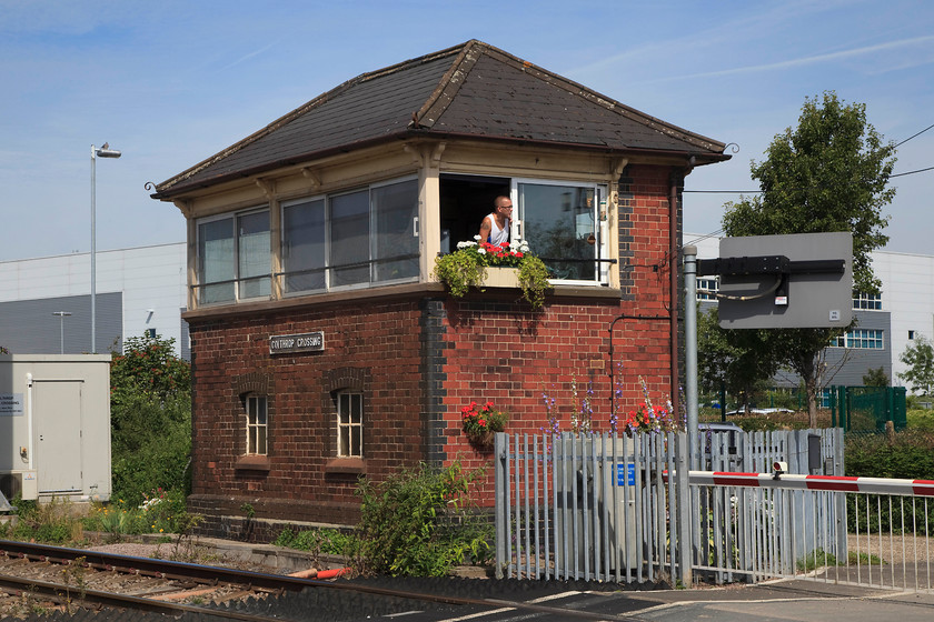 Colthrop Crossing singal box (GW, 1912) 
 With celebrity crossing keeper Eddie Langford leaning out of his window chatting to a lorry driver, Colthrop crossing box looks very smart in the summer sunshine. The box was constructed in 1912 to a typical GW design. Unfortunately, it has gained nasty replacement windows an has lost its chimney but it still stands and is in operation. Eddie Langford appeared on one of the Channel 5 Paddington programmes being filmed inside his box. 
 Keywords: Colthrop Crossing singal box