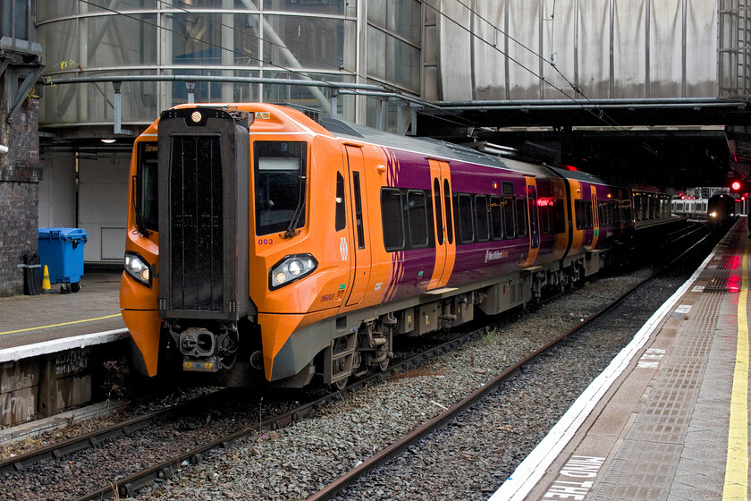 196003, LN 10.52 Birmingham New Street-Shrewsbury (1J48, 2E), Birmingham New Street station 
 One of West Midlands Trains' twenty-six Civity units stands with its first carriage emerging from the gloomy interior of New Street station. 196003 is one of the twelve members of the 196/0xx sub-class composed of two cars that are both powered. This example is about to leave with the 10.52 service to Shrewsbury, a distance of just over forty miles. 
 Keywords: 196003 10.52 Birmingham New Street-Shrewsbury 1J48 BNS station Civity