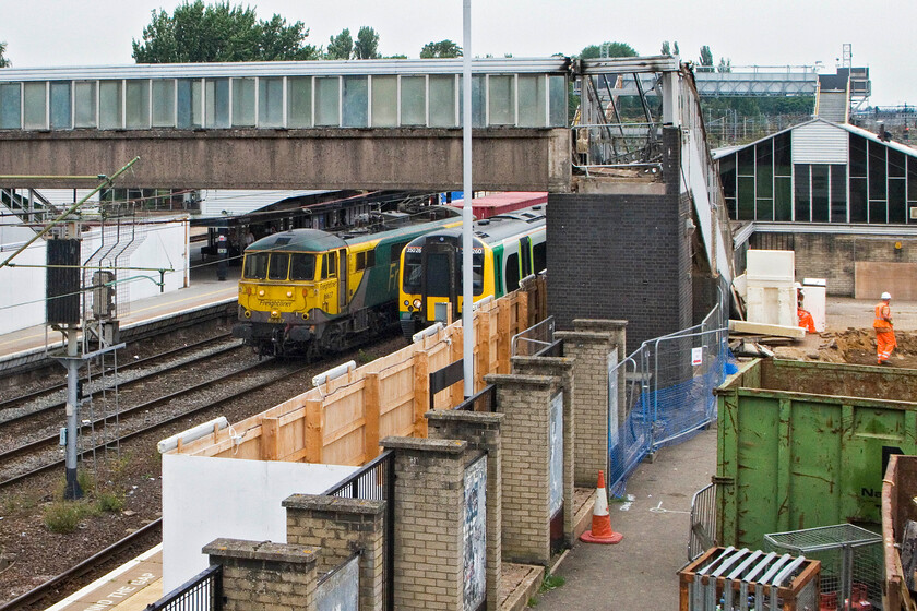 86637, 05.03 Trafford Park-Felixstowe North (4L97) & 350260, LM 12.54 Birmingham New Street-London Euston, Northampton station 
 The former footbridge at Northampton station is seen now partially demolished with its temporary replacement in the background. Work has started in earnest on the former front car park with the archaeological work now completed. 86637 is seen being held working the 05.03 Trafford Park to Felixstowe Freightliner waiting for 350260 to leave working the 12.54 Birmingham to Euston train. 
 Keywords: 86637 05.03 Trafford Park-Felixstowe North 4L97 350260 12.54 Birmingham New Street-London Euston Northampton station Freightliner London Midland Desiro