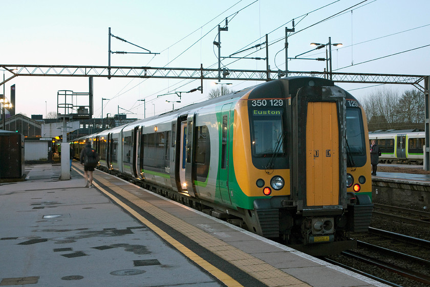 350129, LM 05.57 Coventry-London Euston (1Y80), Northampton station 
 350129 brings up the rear of the 05.57 Coventry to London Euston commuter service at Northampton station. It was a cold March morning so quite why the fellow walking down the platform was wearing shorts was a mystery! 
 Keywords: 350129 LM 05.57 Coventry-London Euston 1Y80 Northampton station