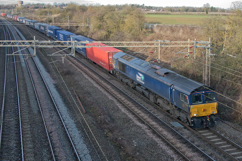 66425, 13.09 DIRFT-Ripple Lane (4L48), Victoria bridge 
 A regular as clockwork Sunday freight on the southern WCML is the 4L48 13.09 (or thereabouts) Daventry to Ripple Lane 'Tesco' Freighliner. It is seen passing Victoria bridge just south of Roade hauled by 66425. This particular DRS liveried Class 66 is one of my most photographed, the majority of which were taken with it hauling this working. 
 Keywords: 66425 13.09 DIRFT-Ripple Lane 4L48 Victoria bridge DRS Freighliner