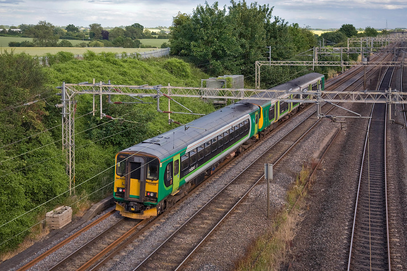 Class 150 & 153366, 17.02 Tyseley-Bletchley sidings ecs (5B03), Victoria bridge 
 A regular working on this section of the WCML is the So empty coaching stock return move from Bletchley to Tyseley. The move is for the London Midland operated Marston Vale units to return to their base in Birmingham for servicing. A balancing working heads back to Bletchley ready for them to take up operations at the start of the following week. Here, a two-car class 150 and single-car 153366 pass Victoria bridge just south of Roade with the 5B03 17.02 Tyseley to Bltechely working. 
 Keywords: Class 150 153366 17.02 Tyseley-Bletchley sidings ecs 5B03 Victoria bridge London Midland Super Sprinter Marston Vale Line