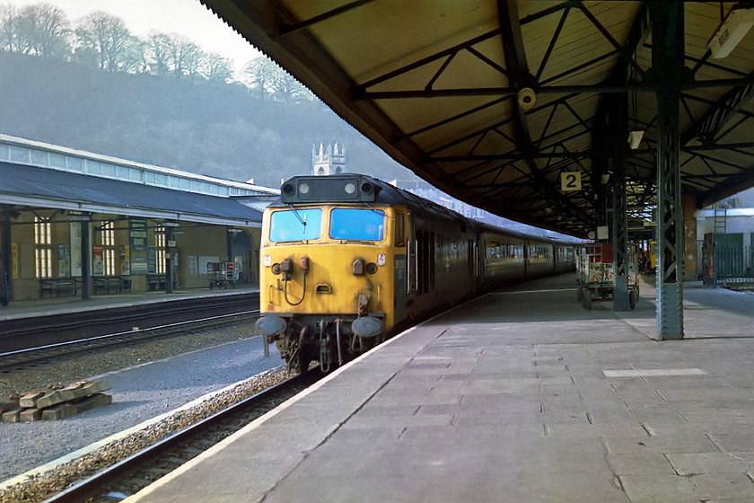 50050, unidentified up working, Bath Spa station 
 50050 arrives at Bath Spa station with an unidentified up working. As I have pointed out on a number of my images taken at Bath, once again, notice the absence of any passengers on either platforms. This was taken on Saturday morning and where is everybody? It looks more like the deck of the Marie Celeste rather than a city's mainline station! Also notice the tower of St. Marks church in the background growing out of the 50's roof! 
 Keywords: 50050 unidentified up working Bath Spa station