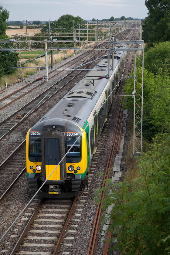 350246, LM 06.14 Birmingham New Street-London Euston (1Y04, RT), Hungate End SP784465 
 Hungate End is a remote spot down a lane that has to be walked or, as I often do, ridden on my bike. There are views both up and down the quadruple section of the WCML but shots are hampered by the wires. It is located just north of Wolverton and just south of the Hanslope Junction crossovers. 350246 heads south forming the 06.14 Birmingham to London Euston. 
 Keywords: 350246 1Y04 Hungate End SP784465