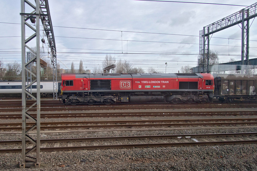 66136, 07.05 Dollands Moor-DIRFT (6M45), Wembley yard 
 Wearing its DB Cargo Yiwu London branding decals and sponsors' logos on its body sides 66136 stands in Wembley Yard. It is at the head of the 6M45 07.05 Dollands Moor to Daventry bottled water train. 
 Keywords: 66136 07.05 Dollands Moor-DIRFT 6M45 Wembley yard