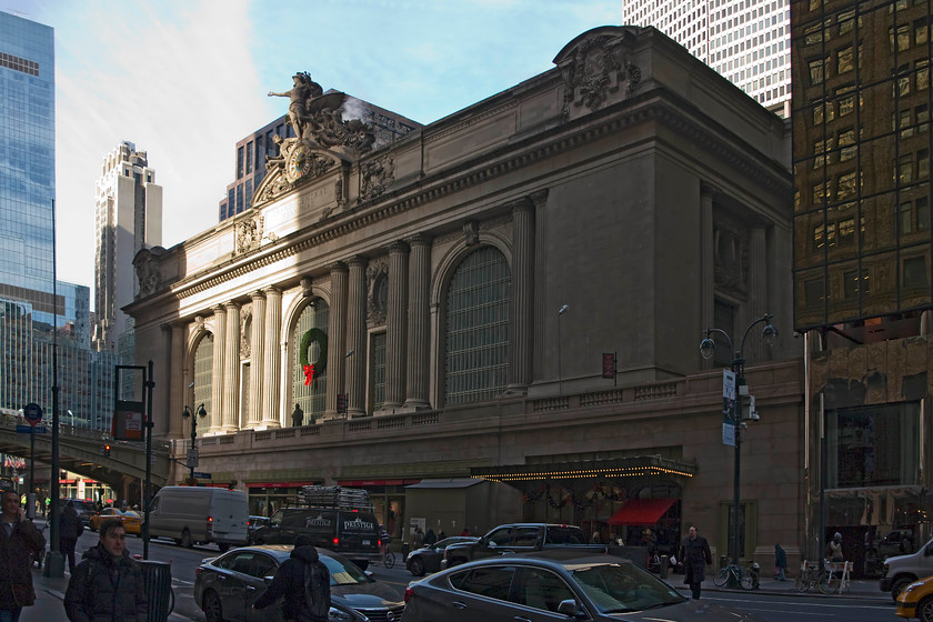 Frontage, New York Grand Central station 
 In a New York winter, with the sun so low in the sky, it is difficult to get a picture of Grand Central station due to the high buildings that surround it. Despite that, the 1913 structure stands proudly on East 42nd Street adorned with its seasonal Christmas wreath. 
 Keywords: Frontage New York Grand Central station