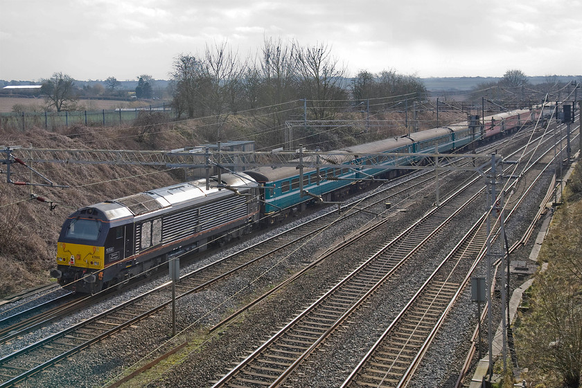 67005, outward leg of The Flame Train, Newcastle-Wembley Central (1Z90), Victoria bridge 
 I suspect that the 67005 'Queen's Messenger' would have led The Flame Train at some time during its journey from Newcastle. However, at this stage of its journey on the Southern WCML near Roade, it is on the rear of the special with 90035 up at the front. The train's destination was Wembley Central for a vast religious convention at the nearby stadium. 
 Keywords: 67005 The Flame Train, Newcastle-Wembley Central 1Z90 Victoria bridge