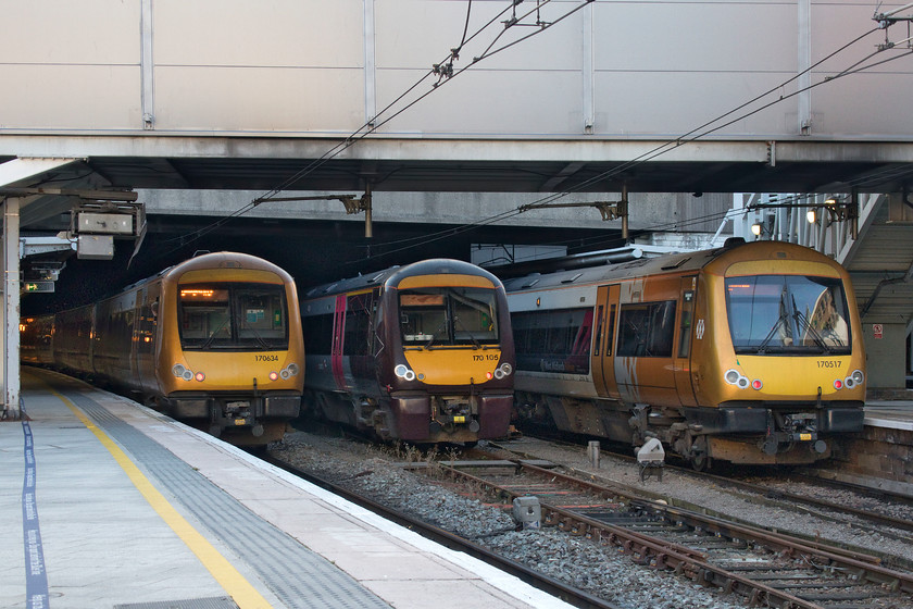 170634, LM 08.36 Great Malvern-Birmingham New Street (1M05, RT), 170105, stabled & 170517, LM 07.32 Hereford-Birmingham New Street (1M57, RT), Birmingham New Street station 
 A furtively taken photograph of a trio of Class 170s at Birmingham New Street station. I had to take this at waist level using the flip-out screen facing upwards as a roving Network Rail employee had just told us that we were not allowed to take photographs on the station without first signing in. Now, I normally bristle when challenged on stations about such matters but as he was absolutely correct in his explanation and actually very helpful about it I could not argue. However, if he had said (as is all too common, unfortunately,) 'you are not allowed to take pictures on stations' then I would have challenged him. So full marks on this occasion for avoiding a row with me as the leader of the Awkward Party!

Left - 170634, just arrived with the 1M05 08.36 from Great Malvern.
Centre- 170015, stabled.
Right - 170517, having just worked the 1M57 07.32 from Hereford. 
 Keywords: 170634 08.36 Great Malvern-Birmingham New Street 1M05 170105 170517 LM 07.32 Hereford-Birmingham New Street 1M57 Birmingham New Street station