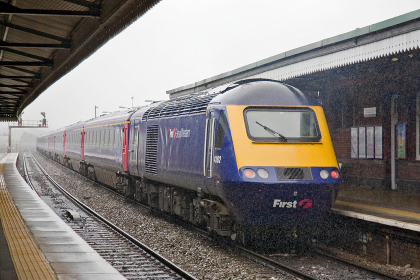 43162, GW 11.06 London Paddington-Plymouth (1C79), Westbury station 
 There is nothing wrong with this image in terms of excessive digital noise, what can be seen is torrential rain! In fact, the rain was so heavy that I had to contend with a going-away shot as I dare not venture outside of the protection afforded by the canopies! 43162 brings up the tail of the 1C79 11.06 Paddington to Plymouth as it gets away from its Westbury stop. 
 Keywords: 43162 11.06 London Paddington-Plymouth 1C79 Westbury station First Great Western HST