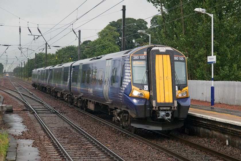 380105, SR 10.50 North Berwick-Edinburgh Waverley (2Y17, 2L), Prestonpans station 
 380105 brings the 10.50 North Berwick to Edinburgh local stopper into Prestonpans station. This train was pretty busy, no doubt with many shoppers going into Edinburgh for some Saturday morning retail therapy! Notice the 11.00 Edingburgh to King's Cross on the up line disappearing into the wet murk! 
 Keywords: 380105 10.50 North Berwick-Edinburgh Waverley 2Y17 Prestonpans station