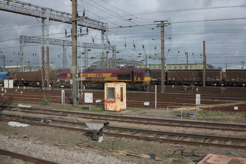 66104, unidentified up working, Wembley Yard 
 66104 sits at the head of an unidentified up Freightliner working in Wembley Yard. Notice Wembley Stadium against the stormy looking sky in the background. 
 Keywords: 66104 Wembley Yard