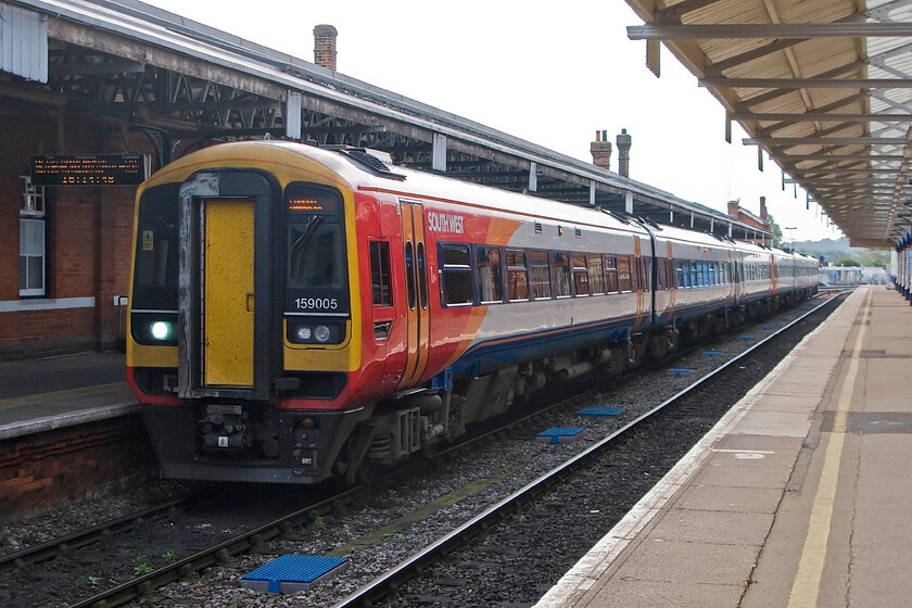 159005, SW 13.26 Exeter St. David's-London Waterloo (1L82), Salisbury station 
 159005 and a fellow class member pause at Salisbury station working the 13.26 Exeter St. David's to London Waterloo service. The first part of this journey from the south-west is relatively slow on large sections of singled track but from Salisbury onwards, the average speed picks up with fewer stops. 
 Keywords: 159005 SWT 13.26 Exeter St. David's-London Waterloo 1L82 Salisbury station South West Trains