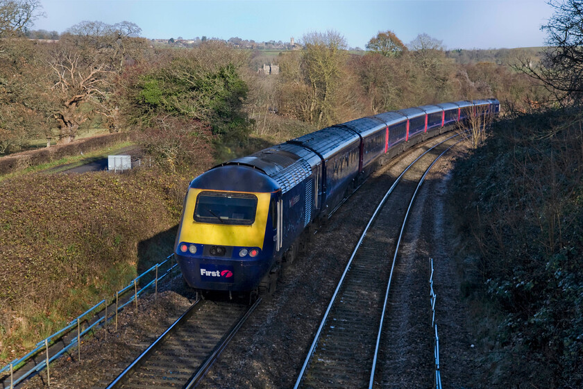 Class 43, GW 12.30 Bristol Temple Meads-London Paddington (1A17), Middlehill footbridge ST805680 
 By way of comparison, the same train seen in the last photograph is seen again going away from the camera. The previous image was very much into the low winter sunshine creating a 'glint shot' whilst this one, with the light square behind me, gives some very different lighting conditions. An unidentified Class 43 power car propels the 12.30 Bristol to Paddington service on the steady climb towards Box tunnel passing Middlehill footbridge. This location is just adjacent to the A4 road that can be seen to the left along with the tower of Colerne's St John the Baptist church on the skyline. 
 Keywords: Class 43 12.30 Bristol Temple Meads-London Paddington 1A17 Middlehill footbridge ST805680 First Great Western HST