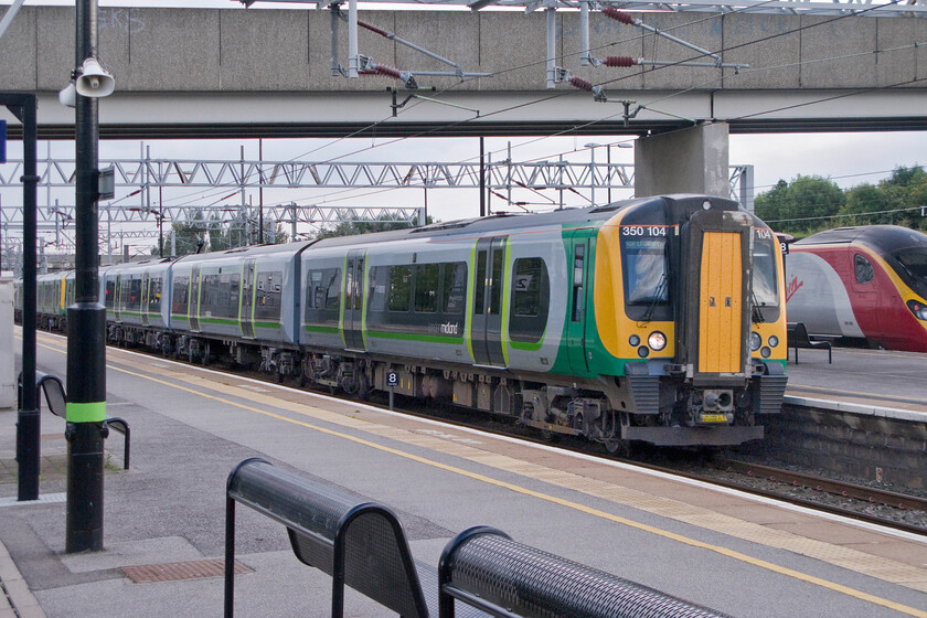 350104, LM 16.13 London Euston-Milton Keynes Central (1N21) & Class 390, VT 15.50 Birmingham New Street-London Euston (1B64), Milton Keynes Central station 
 As the 15.50 Birmingham New Street to Euston Pendolino service leaves Milton Keynes station 350104 arrives working the 16.13 Euston terminating service. 
 Keywords: 350104 16.13 London Euston-Milton Keynes Central 1N21 Class 390 15.50 Birmingham New Street-London Euston 1B64 Milton Keynes Central station London Midland Desiro Virgin Trains Pendolino