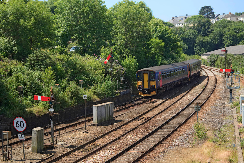 153382 & 153361, GW 12.20 Truro-Falmouth Docks (2F77, RT), Truro 
 153382 and 153361 pass the quartet of lower quadrant signals at the western end of Truro station departing with the 12.20 to Falmouth Docks. As can be seen, it was high summer (the longest day) and the sun was very bright creating problems with the camera due to its very bright and overhead position; not an ideal time to take photographs! 
 Keywords: 153382 153361 2F77 Truro