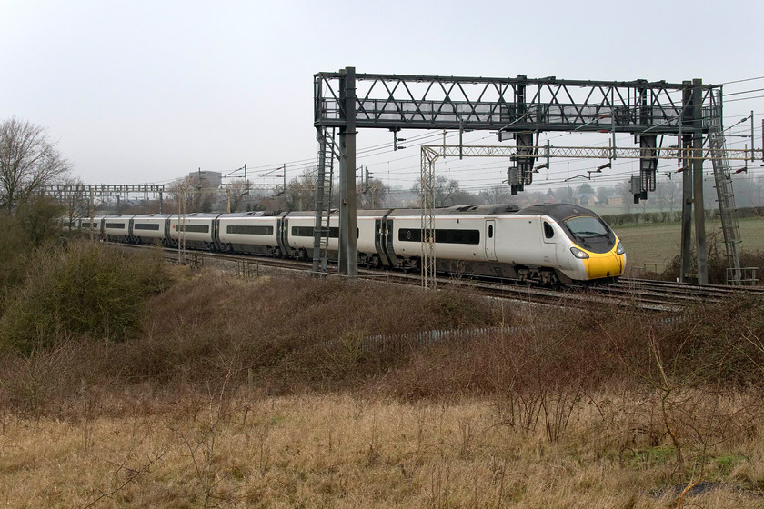 390005, VT 06.52 Edinburgh Waverley-London Euston (9M50, 11L), Roade Hill 
 I have not used this particular location on Roade Hill between Ashton and the village of Roade for a long time, being disappointed at how overgrown it has been getting. However, in the winter months with less foliage, a tolerable photograph can be taken. 390005 'City of Wolverhampton' heads south still wearing its 'nude' de-branded livery working the 06.52 Edinburgh to Euston service. Something had gone badly awry earlier in its journey just south of Lancaster as it was running for some time over an hour late. However, control re-routed the train from its planned route via Wolverhampton and New Street through to the Trent Valley route from Stafford. This meant that by the time it passed me here in south Northamptonshire it was just twelve minutes delayed - time it did not make up by the time it arrived into London. 
 Keywords: 390005 06.52 Edinburgh Waverley-London Euston 9M50 Roade Hill Avanti West Coast Pendolino City of Wolverhampton