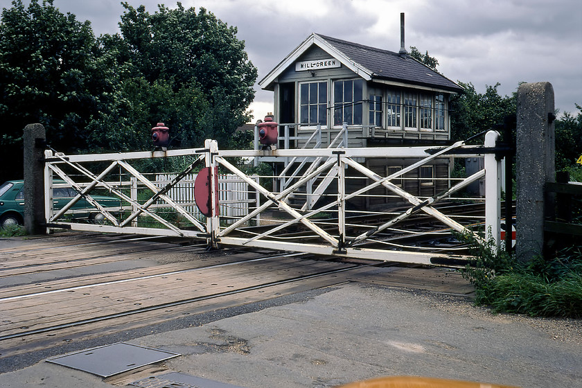 Mill Green Signal Box (GE, 1882) 
 Mill Green signal box was located on the northern edge of Spalding where the railway crossed Woolram Wygate Road. In this photograph the Great Eastern 1882 box still controlled mechanical gates and a crossover between the up and down lines. The box survived until 2014 when the whole line from Spalding to Lincoln was 'modernised' in Network Rail parlance in one fell swoop. Notice in this photograph the signalman's rather natty green koda 120 parked close to the box. 
 Keywords: Mill Green Signal Box