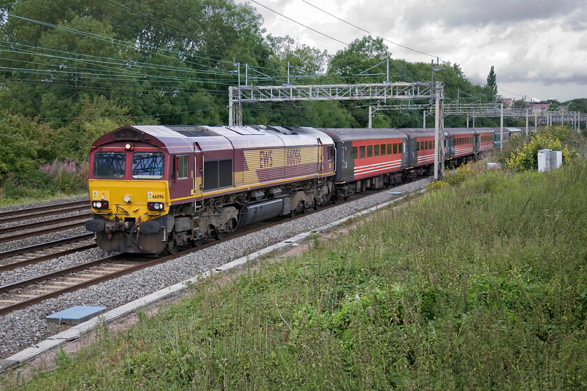 66096, 08.47 Crewe-Southall ECS (5Z93), Roade 
 66096 leads a motley collection of stock past Roade as the 08.47 Crewe to Southall 5Z93 ECS move. I tried to ascertain the purpose of this ECS move but despite studying the next subsequent few charters I could find none that utilised the Mk. IIf stock seen here. 
 Keywords: 66096 08.47 Crewe-Southall ECS 5Z93 Roade