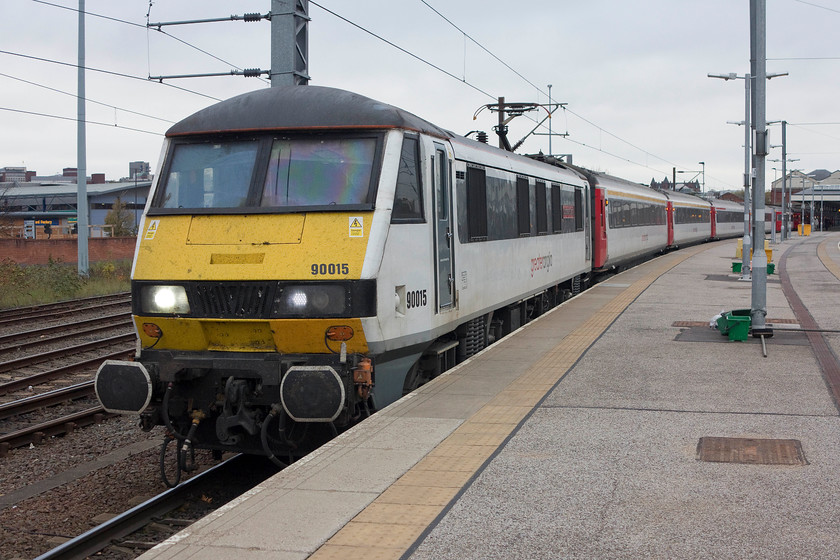 90015, 15.30 Norwich-London Liverpool Street (1P49, 1E), Norwich station 
 90015 is ready to leave with the 15.30 to London Liverpool Lime Street. The Greater Anglia livery that the class 90s and the stock carry is bright and smart but I suspect that the cleaning staff have to work hard to keep it looking good. 
 Keywords: 90015 15.30 Norwich-London Liverpool Street 1P49 Norwich station