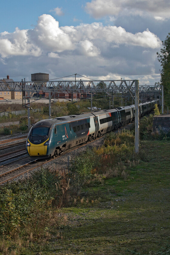 390112, VT 13.43 London Euston-Blackpool North (9P77, RT), site of Roade station 
 Under a dramatic skyscape that I have tried to include as much of as possible by turning the camera to a portrait orrientation. 390112 passes the site of Roade's former station working the 9P77 13.43 Euston to Blackpool North Avanti service. 
 Keywords: 390112 13.43 London Euston-Blackpool North 9P77 site of Roade station Avanti West Coast Pendolino