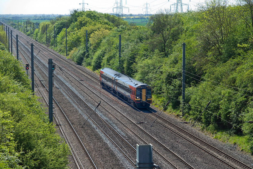 158862, EM 08.57 Norwich-Liverpool Lime Street (1R74, 3L), High brigde, Westby SK962271 
 Taken rather into the sun from the lofty heights of the appropriately named High bridge 158862 works the 08.57 Norwich to Liverpool Lime Street. This is a bridge that I first visited back in August 1978, then, the view was much more open with the virtual absence of trees on the embankments and obviously with no electrification hardware. However, the high tension transmission wires and pylons are still there, see https://www.ontheupfast.com/v/photos/21936chg/25410359604/x55017-15-00-london-kings-cross-aberdeen The other difference worth noting is the difference in what is seen running then and now! 
 Keywords: 158862 08.57 Norwich-Liverpool Lime Street 1R74 High brigde, Westby SK962271