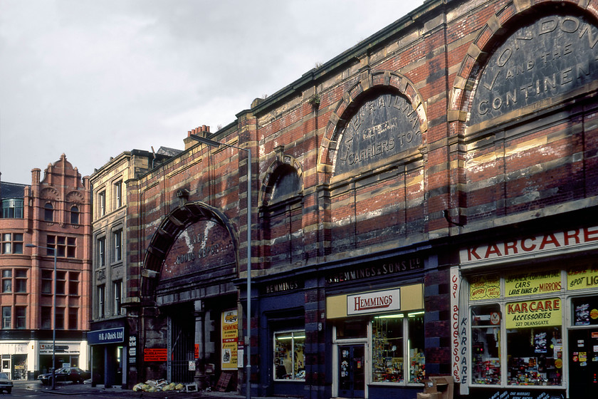 Former LNER goods depot, Deansgate, Manchester 
 Looking roughly south down Manchester's Deansgate the rather run-down former LNER goods depot is seen in a burst of evening sunshine after a recent shower of rain. Just over a year previous to this photograph being taken the building had been Grade II listed. It seemed to attract car spare shops with no less than three located adjacent to each other, with Karcare (sic) and Hemmings visible here. The building at the end of the former goods depot on the corner houses a well known Northern car franchise H & J Quick who started in the motor trade back in 1914 and are still trading today. As a Ford dealership, their simple mantra was and still remains 'Quicks for Ford'. As part of the recent restoration of the fine former LNER building, the Quick's building has been demolished but the superb gabled building the other side of Peter Street has been restored now housing various restaurants and bars including the oddly named Dirty Martini! 
 Keywords: Former LNER goods depot Deansgate Manchester