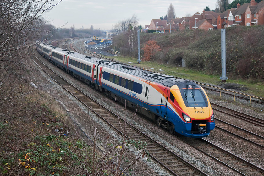 222006, EM 11.29 Sheffield-London St. Pancras (1C40, 1L), Headlands bridge 
 222006 'The Carbon Cutter' passes Headlands bridge just south of Kettering station with the 11.29 Sheffield to St. Pancras working. This area has changed beyond all recognition since my first visit in 1978. There were a vast number of sidings here with no urban development. Kettering station signal box was situated at a spot in the distance just about above the articulated arm of excavator. 
 Keywords: 222006 11.29 Sheffield-London St. Pancras 1C40 Headlands bridge