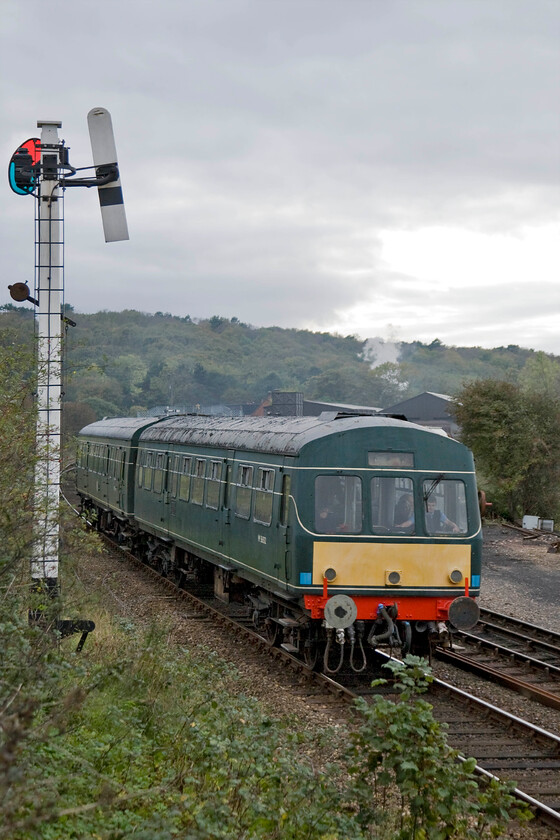 M56352 & M51192, 15.00 Holt-Sheringham, Weybourne yard 
 The 15.00 Holt to Sheringham North Norfolk Railway service leaves Weybourne passing one of its superb GNR somersault wooden signals. Whilst M56352 and M51192 head east towards Sheringham the balancing working towards Holt can be seen climbing toward Kelling Heath through the trees with 44767 'George Stephenson' leading. 
 Keywords: M56352 M51192 15.00 Holt-Sheringham Weybourne yard Class 101 DMU