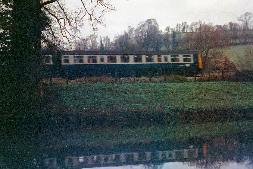 DMU, unidentified up working, Avon Valley between Avoncliff & Bradfrod-on-Avon 
 A very poor quality image scanned from a negative of dubious quality! With a reflection in the remarkably calm River Avon I managed to capture this DMU working between Bradford-on-Avon and Avoncliff on my hand-me-down Exa camera. Shots like this were very difficult due to the reversed waist level viewfinder so, as an 11 year old, I think that I did pretty well! 
 Keywords: DMU, unidentified up working Avon Valley between Avoncliff & Bradford-on-Avon River Avon