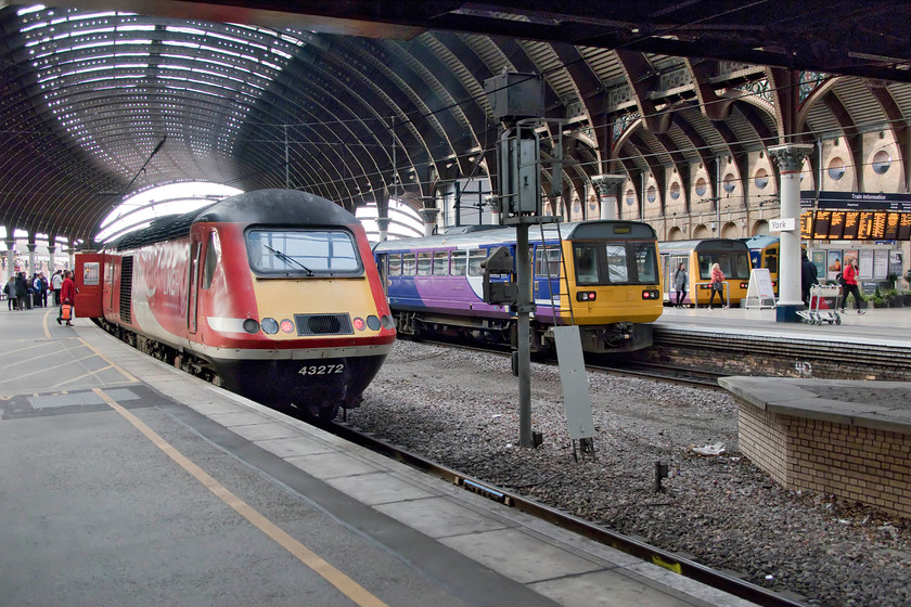 43272, VT 07.30 Edinburgh Waverley-London King`s Cross (1E05, 25L), 142012, NT 10.15 York-Sheffield (2Y87, 6L) & 142011, NT 09.24 Leeds-York (2T09, 11L), York station 
 By now, I would have expected a scene like this at York to be confined to history! To the left, the 07.30 Edingburgh to King's Cross HST, with 43272 bringing up the rear, waits at platform four. The two consecutively numbered Pacers are 142012 that will soon work the 10.15 to Sheffield and 142011 that has just terminated with the 09.24 from Leeds. Notice that the HST power car has non-standard numbers that are larger than the usual ones. 
 Keywords: 43272 07.30 Edinburgh Waverley-London King`s Cross 1E05 142012, NT 10.15 York-Sheffield 2Y87 142011 09.24 Leeds-York 2T09 York station HST Pacer