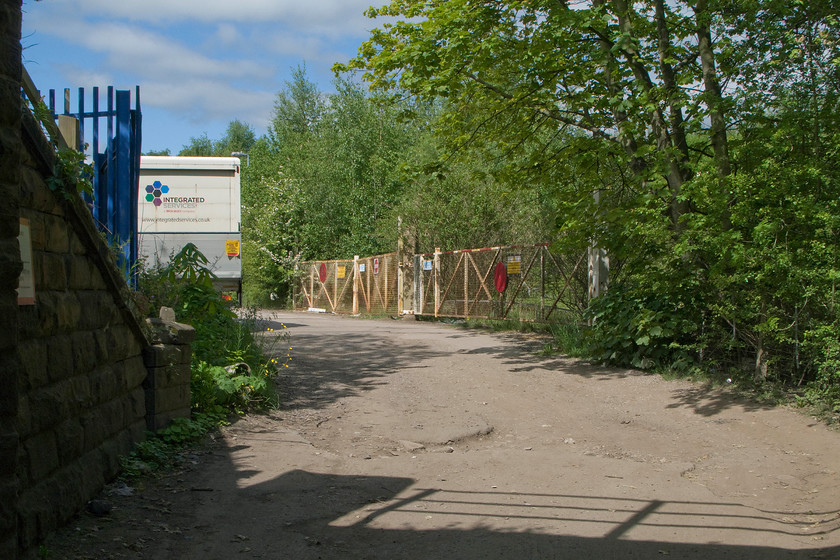 Former level crossing gates, Forge Lane, Horbury Junction 
 At the end of Forge Lane that leads from the village of Horbury is a country park centred around some lakes that were formally quarries. Taken standing under the bridge that carries the Wakefield to Barnsley line south from Horbury Junction this view shows Forge Lane and the now disused crossing gates. These gates afforded access to the former extensive Charles Roberts and Co Ltd wagon works. 
 Keywords: Former level crossing gates Forge Lane Horbury Junction